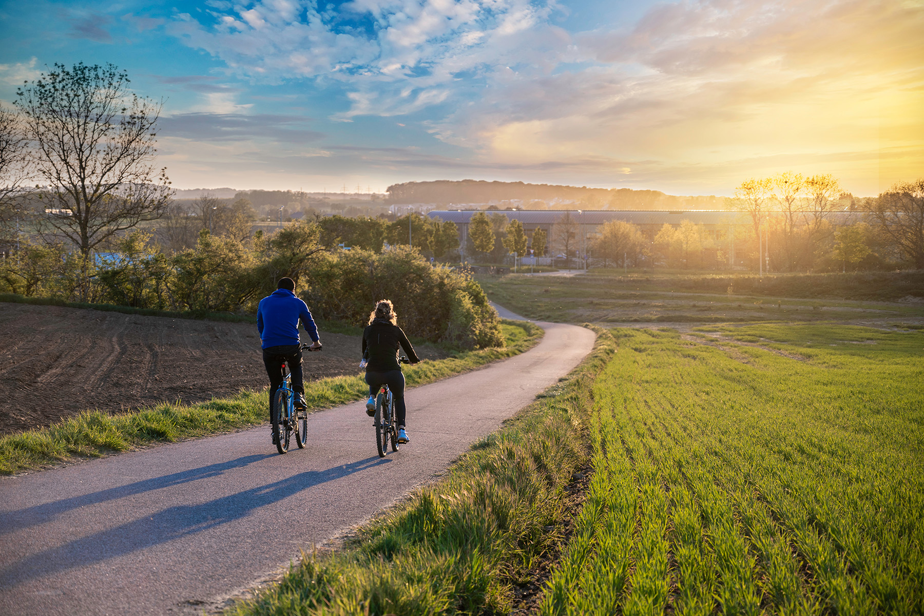 A couple cycling on a date in the Luxembourg countryside